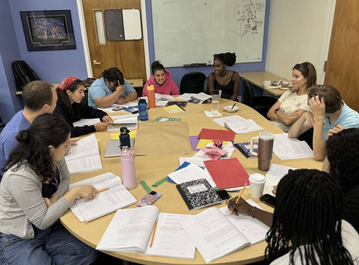 Youth mentors studying together around a table